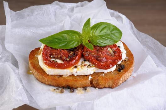 Bruschetta with feta and sun-dried tomatoes slices spiced
