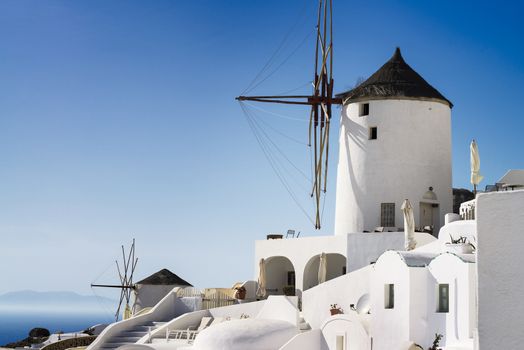 windmill of Oia at sunny day close up, Santorini, toned