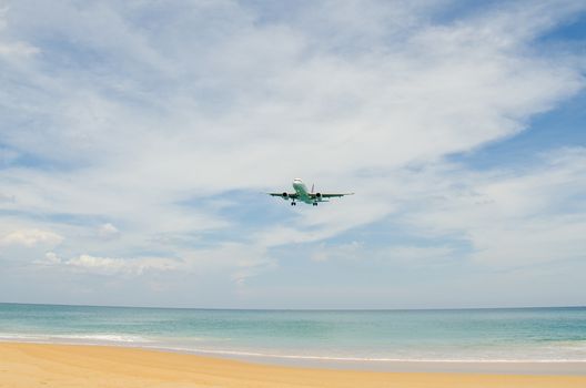 Airplane landing at airport, runway near the beach.