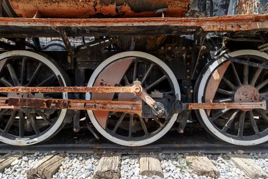 Close up detailed view of historical old rusty iron train locomotives.