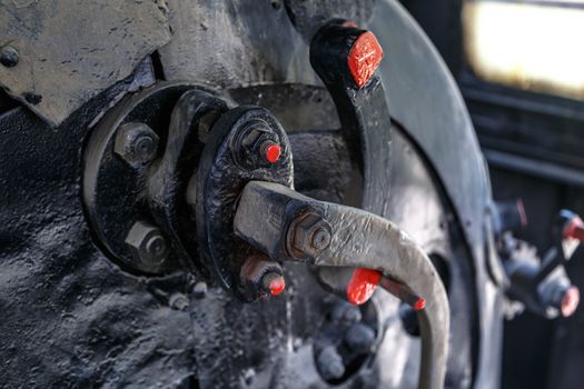 Close up detailed view of industrial iron valves and cables used in mechines.