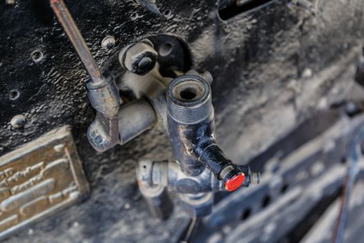 Close up detailed view of industrial iron valves and cables used in mechines.