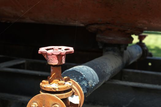 Close up detailed view of industrial iron valves and cables used in mechines.