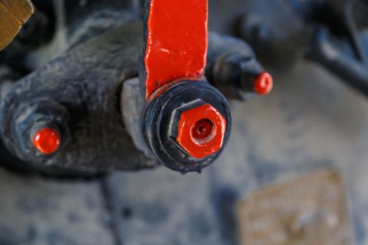 Close up detailed view of industrial iron valves and cables used in mechines.