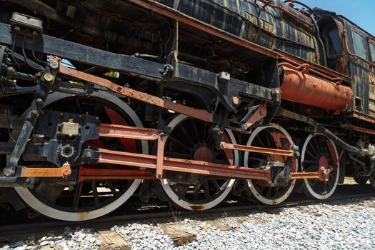 Close up detailed view of historical old rusty iron train locomotives.