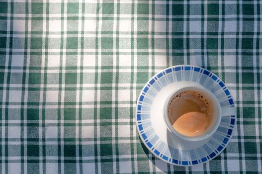 A little cup of coffe on a table in the garden