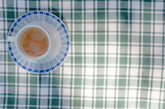 A little cup of coffe on a table in the garden