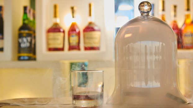 Guatemalan rum under a glass dome with smoke.