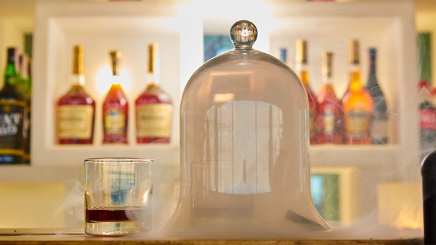 Guatemalan rum under a glass dome with smoke.