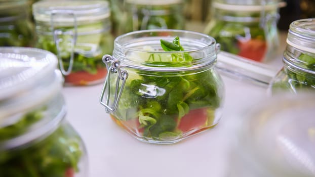 vegetable salad in glass jar on white background. Shallow dof
