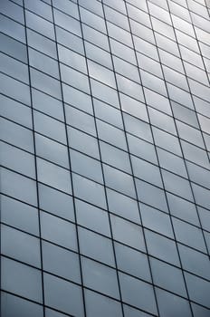 Panel glass windows of modern buildings and sky reflect