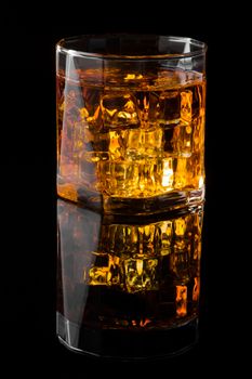 Whisky and Ice on a black glass table