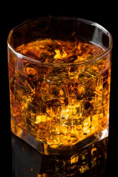Whisky and Ice on a black glass table