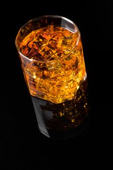 Whisky and Ice on a black glass table