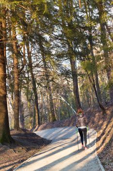 Young fit woman hiking in nature. Adventure, sport and exercise. Copy space.