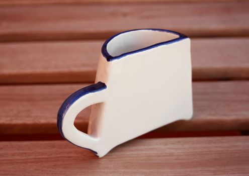 Half a cup on teakwood plank
