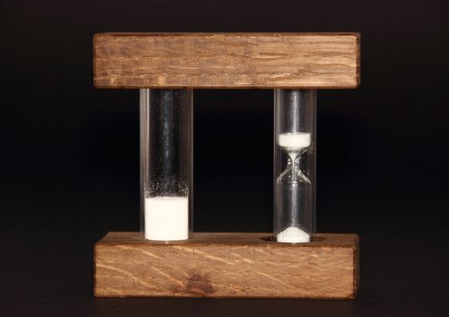 Isolated hourglass with analog and digital speed on black background