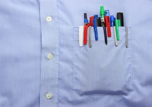 Blue shirt pocket with many different ballpoint pen and bottoms