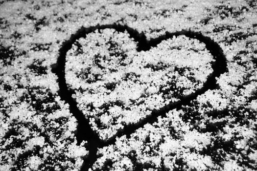 Heart drawing on windshield covered with hail