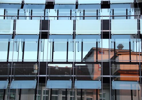 Window reflection of old building in office facade - horizontal