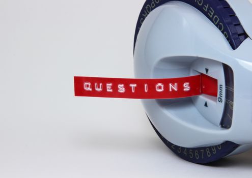 Red stamp letter label with the word Questions