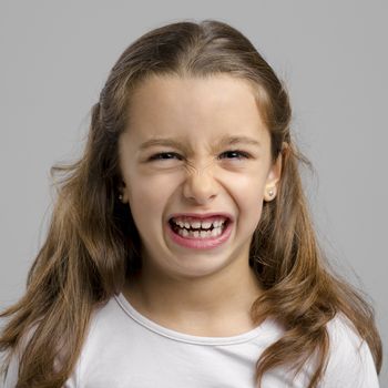 Portrait of a little girl with a funny expression