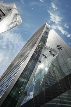 Moscow, Russia - June 10, 2016: Cleaning windows on the side of a high rise building. Moscow City. View of skyscrapers Moscow International Business Center.