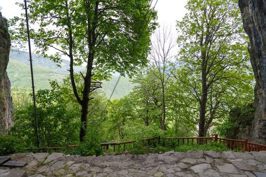 Landscape view of high mountains of Black Sea region with big green trees around, on cludy sky background.