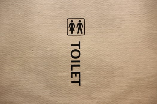 Unisex Toilet Sign on White Structured Wall