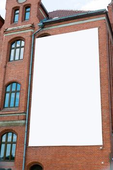 Blank billboard canvas on brick wall. Outdoor advertising in the city.