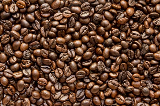 the texture of the coffee beans roasted Brown background