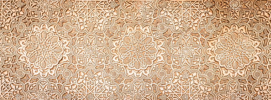 Wall detail of Alhambra UNESCO site in Granada - South of Spain. 600 years old arabic characters.