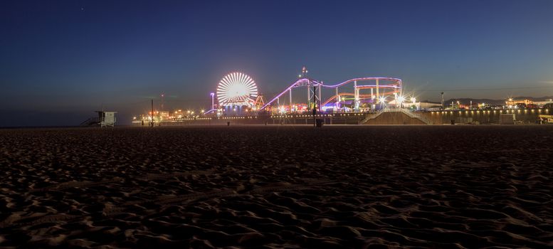 Santa Monica, California — April 24, 2016: Santa Monica Pier boardwalk lit up at night in Southern California. Editorial use.