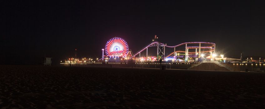 Santa Monica, California — April 24, 2016: Santa Monica Pier boardwalk lit up at night in Southern California. Editorial use.