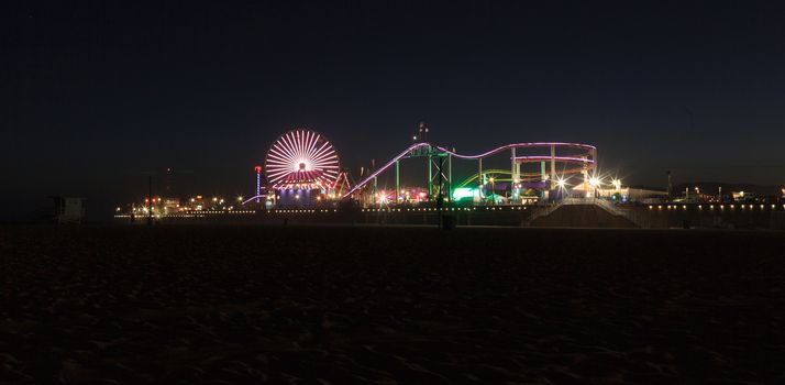 Santa Monica, California — April 24, 2016: Santa Monica Pier boardwalk lit up at night in Southern California. Editorial use.