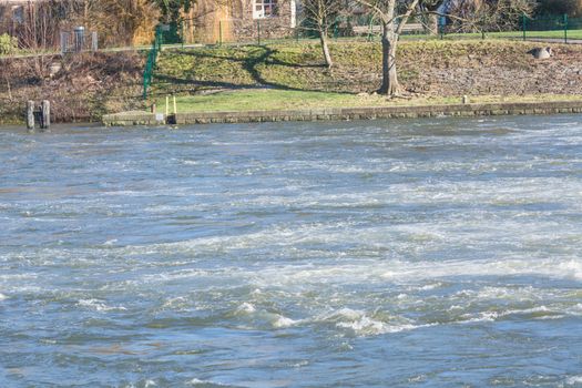 Flooded embankment in heavy rain in Essen Werden in Germany.