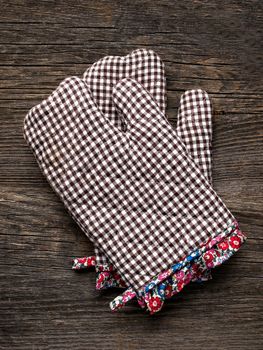 close up of rustic kitchen oven baking mitten glove
