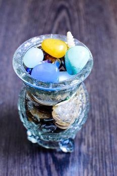 Colorful semiprecious stones in a glass vase. closeup