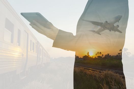 Double Exposure of BusinessMan Hold Tablet and Train, Airplane as Business Transportation, Business Travel or Logistics Concept. 