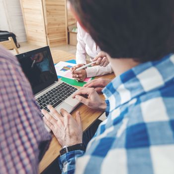 Diverse people working with financial reports and laptop