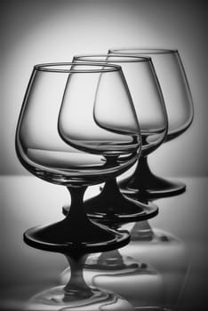 Three empty glasses in white light