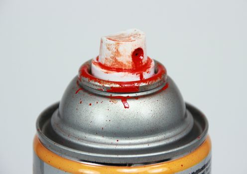 Top of spray can with red paint