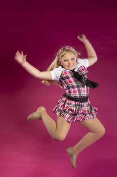 A young child posing in a studio environment