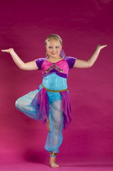 A young child posing in a studio environment
