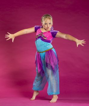 A young child posing in a studio environment