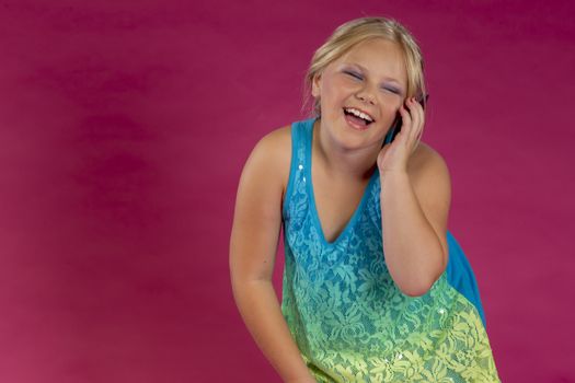 A young child posing in a studio environment with an electronic device.