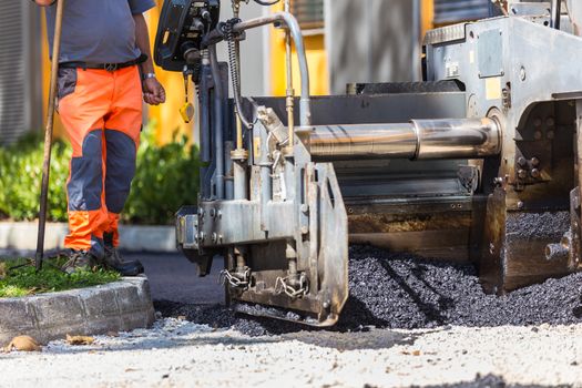 Heavy machiners construction works during asphalting road.