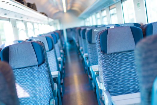 Modern european economy class fast train interior. Inside of high speed train compartment.