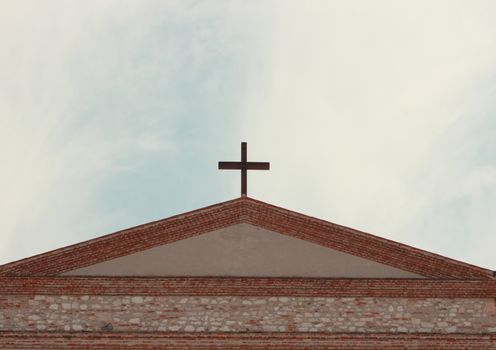 Top of temple with cross and blue sky