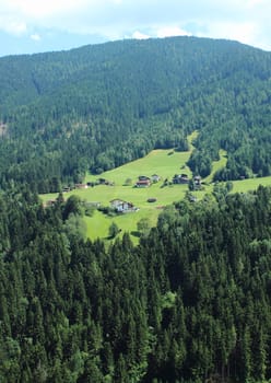 Isolated houses on hill side in the fantastic Alps